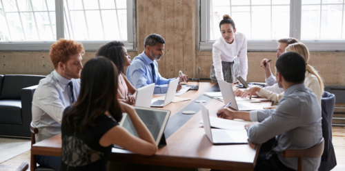 group of adults sitting around a conference table working