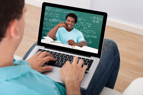 A student with a laptop takes a class remotely during the COVID-19 pandemic.