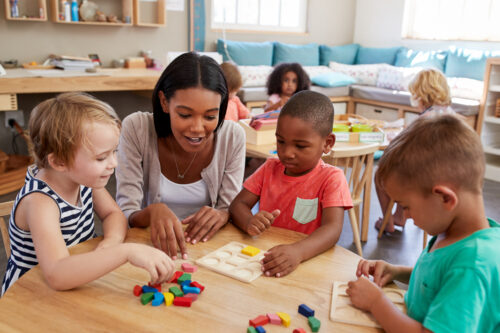 Pre-k students working with a teacher