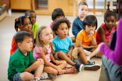 Pre-K students sitting on floor
