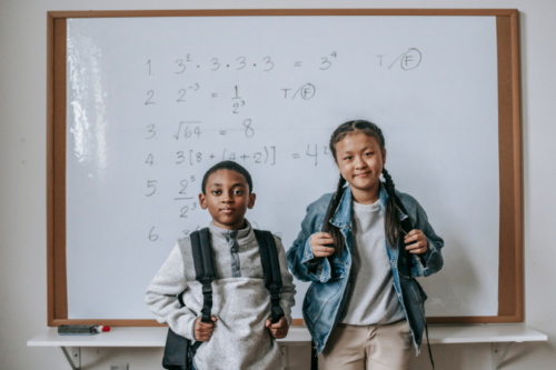 students in front of math class whiteboard