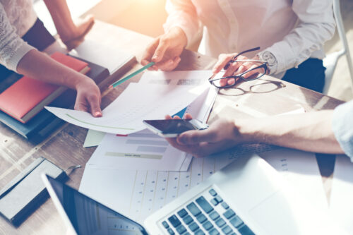 Close up of adults reviewing papers